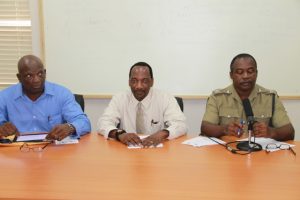 (L-R) Assistant Commissioner of Police Robert Liburd, Assistant Secretary in the Premier’s Ministry Kevin Barrett and Chairperson of the closing ceremony Inspector Conrad Bertie sitting at the head table at The Royal St.Christopher and Nevis Police Force Traffic Wardens Training Course Closing Ceremony on December 5th, 2014, at the Cotton Ground Police Station
